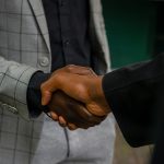 A close-up shot of a professional handshake, symbolizing business agreement and partnership.